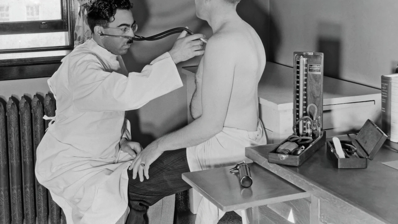 Doctor examining a patient in a vintage photo