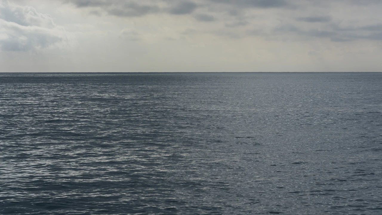 Grey clouds over a calm ocean horizon