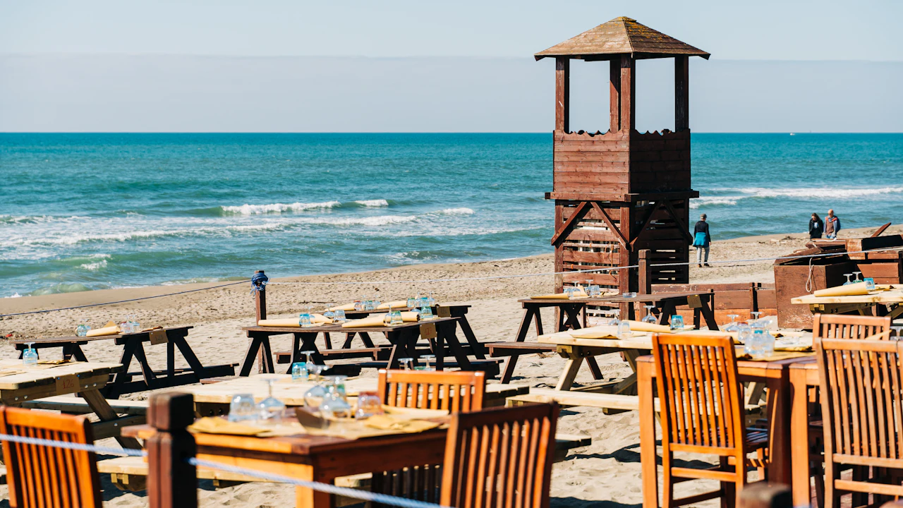 Beachfront restaurant tables beside the sea
