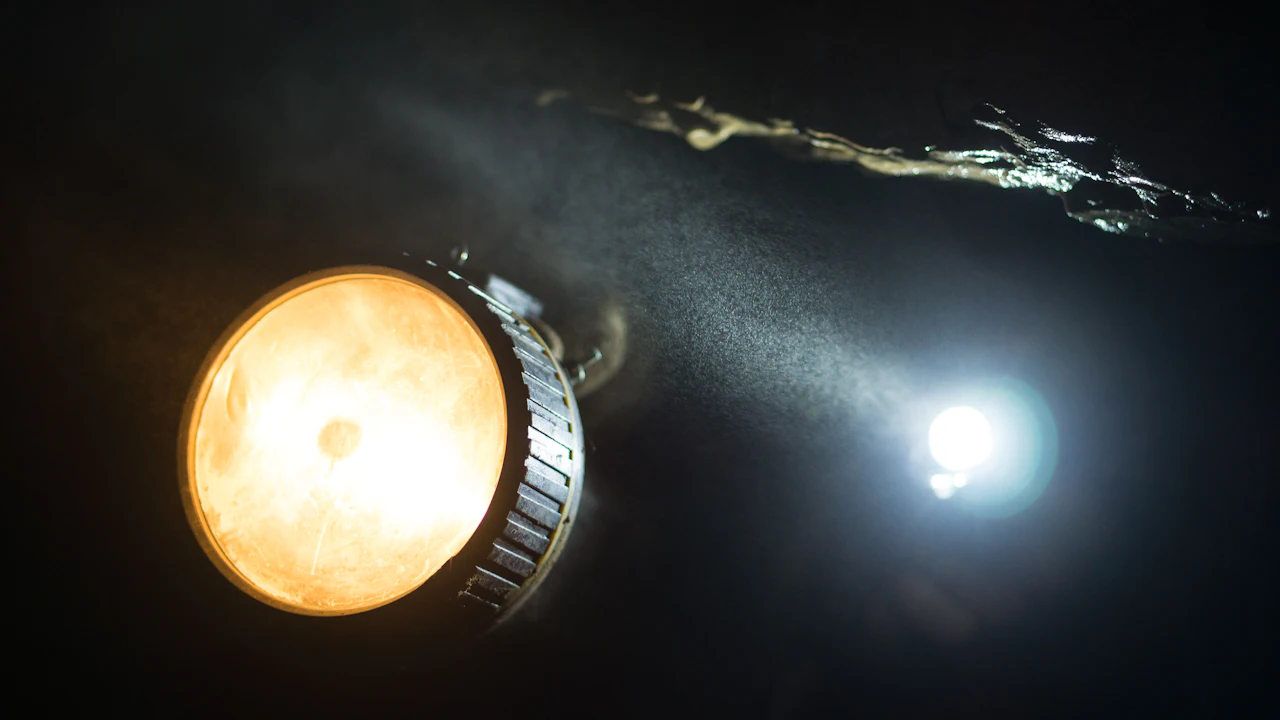 Dive light shining in dark water