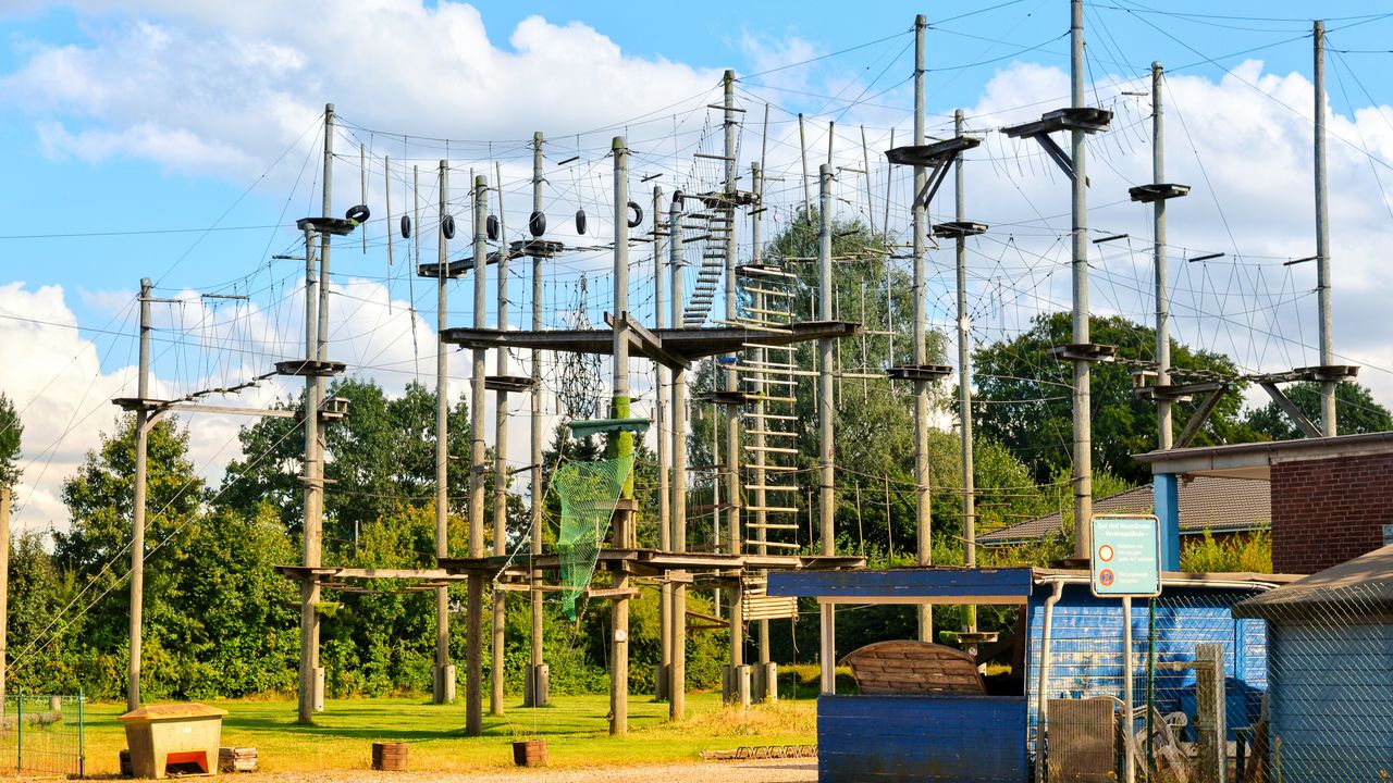 Tall high ropes course with wooden poles and platforms