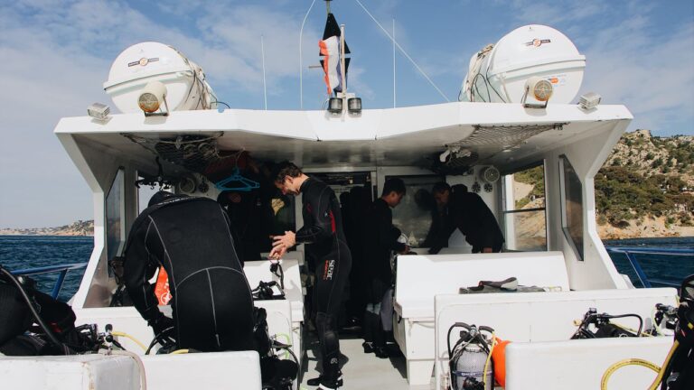 Divers and crew getting ready on a boat deck