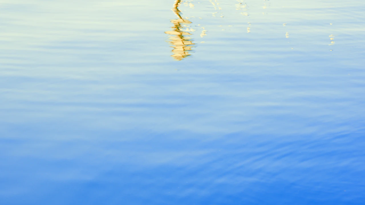 Calm blue sea surface with a reflection