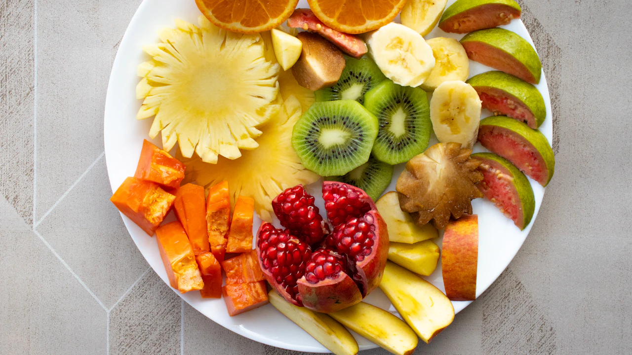 Plate of sliced fresh tropical fruit including watermelon and pineapple