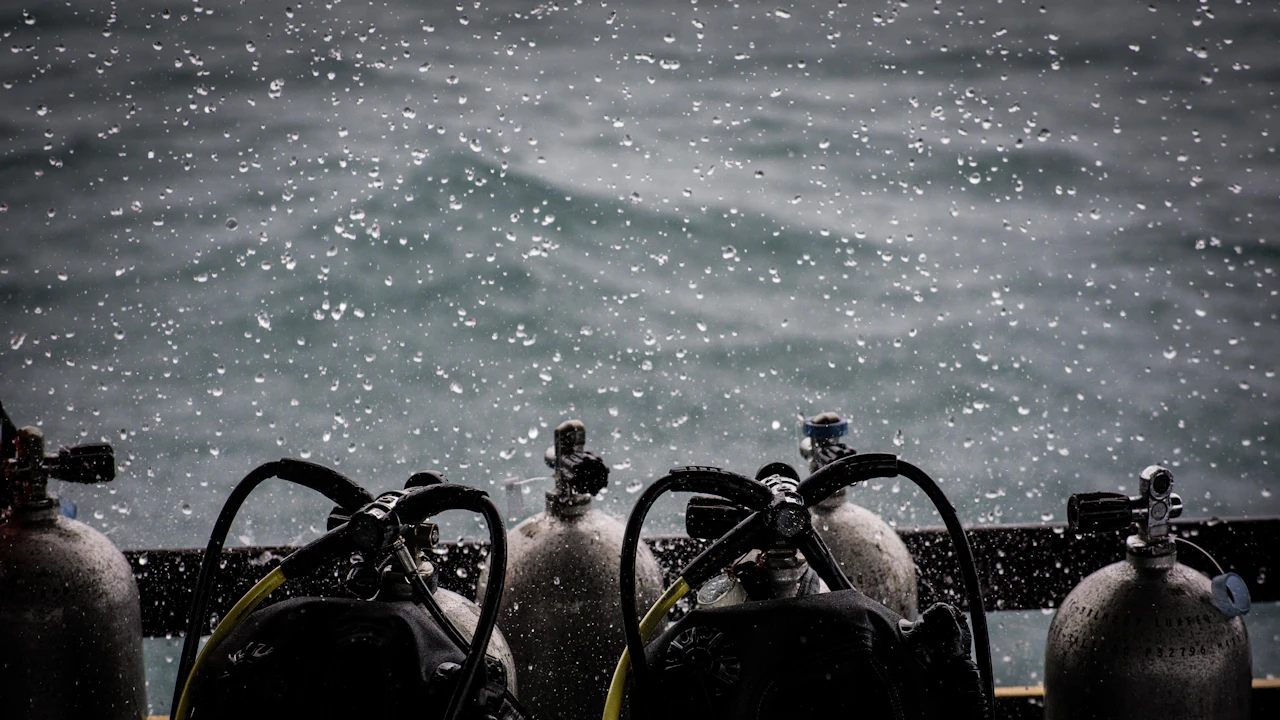 Row of scuba tanks with regulators on a boat