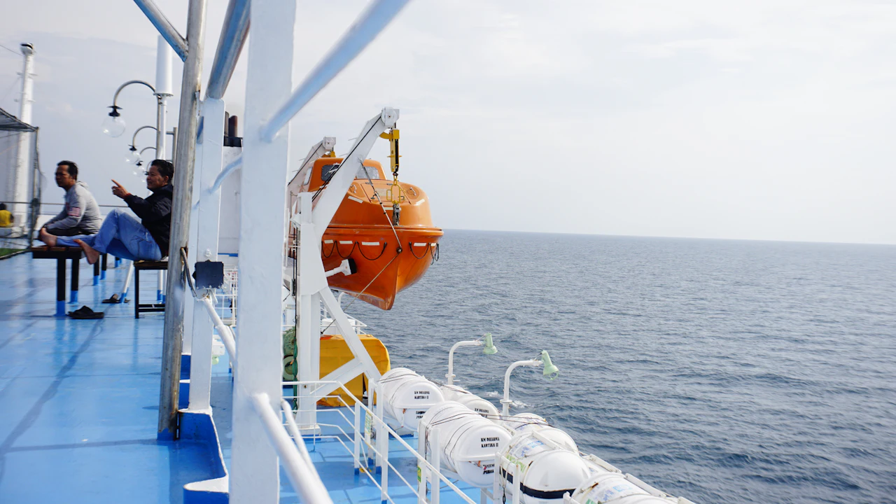 Passengers sitting on the deck of a large boat