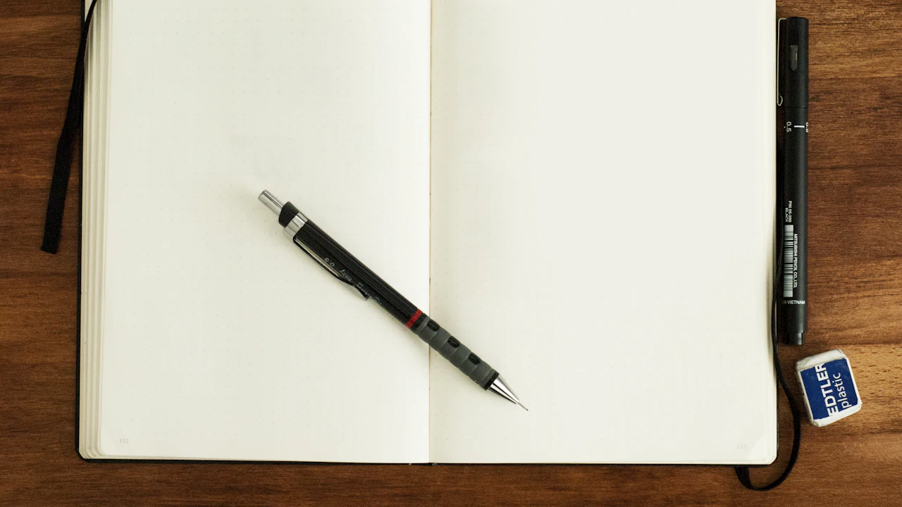 Open notebook with a pencil