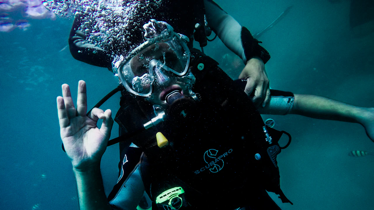 Diver giving the OK hand signal underwater