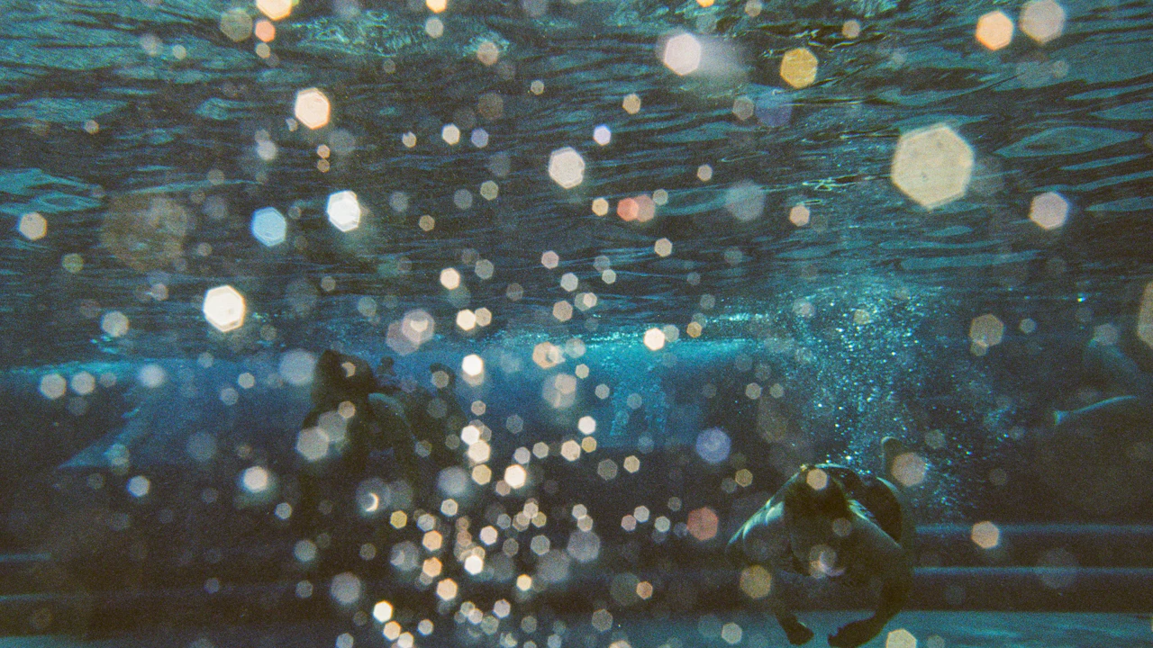 Sunlit bubbles glittering in blue water