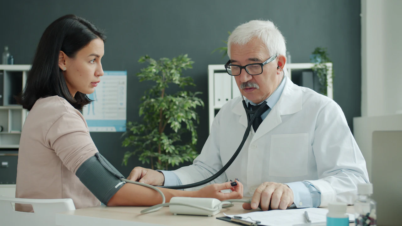 Doctor measuring a patient blood pressure in a clinic