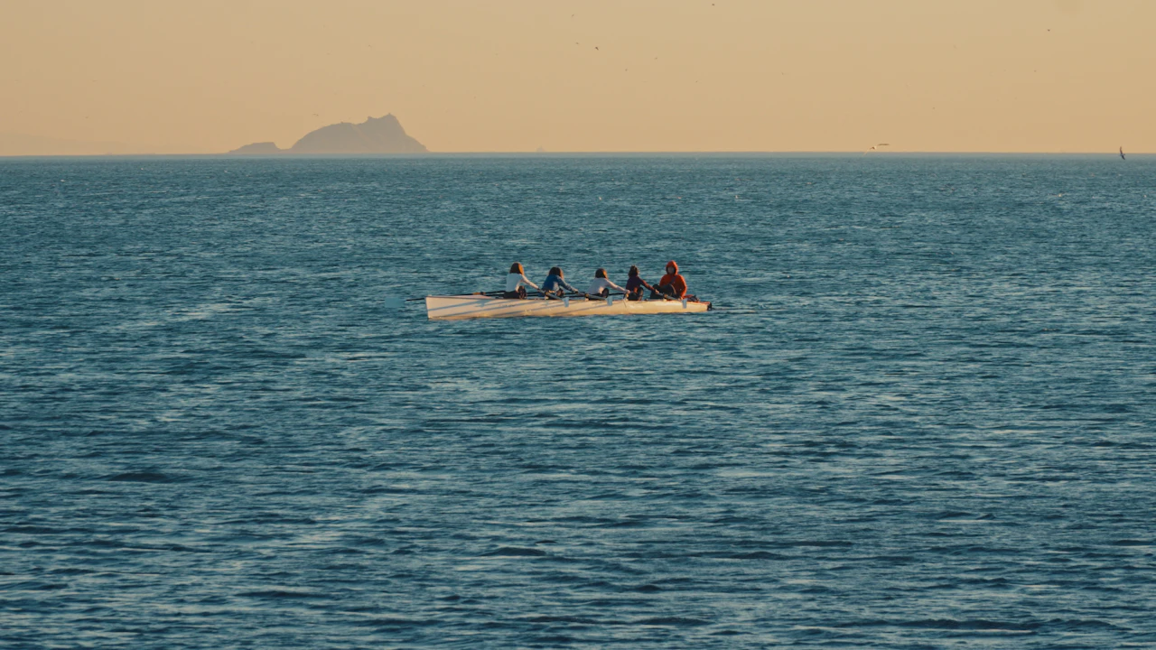 Small boat with people crossing a calm sea