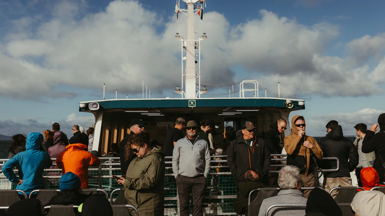 Passengers standing on the deck of a ferry