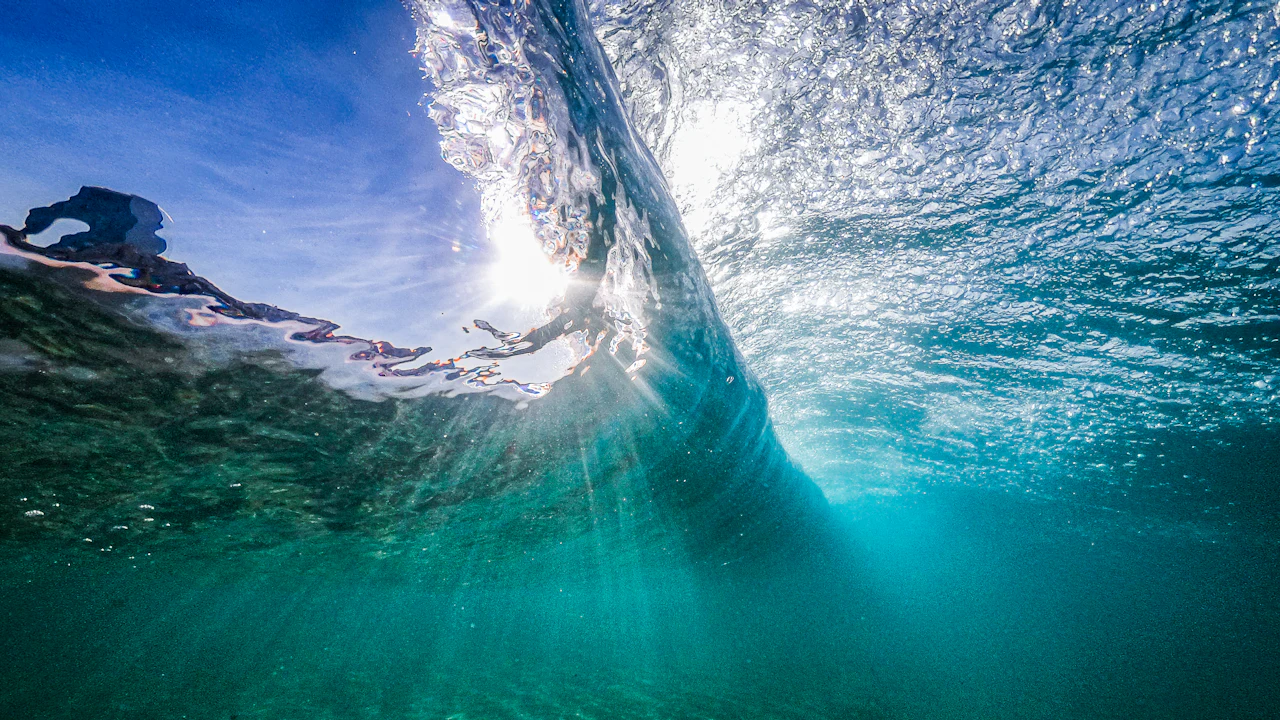 Diver beneath a breaking wave near the surface