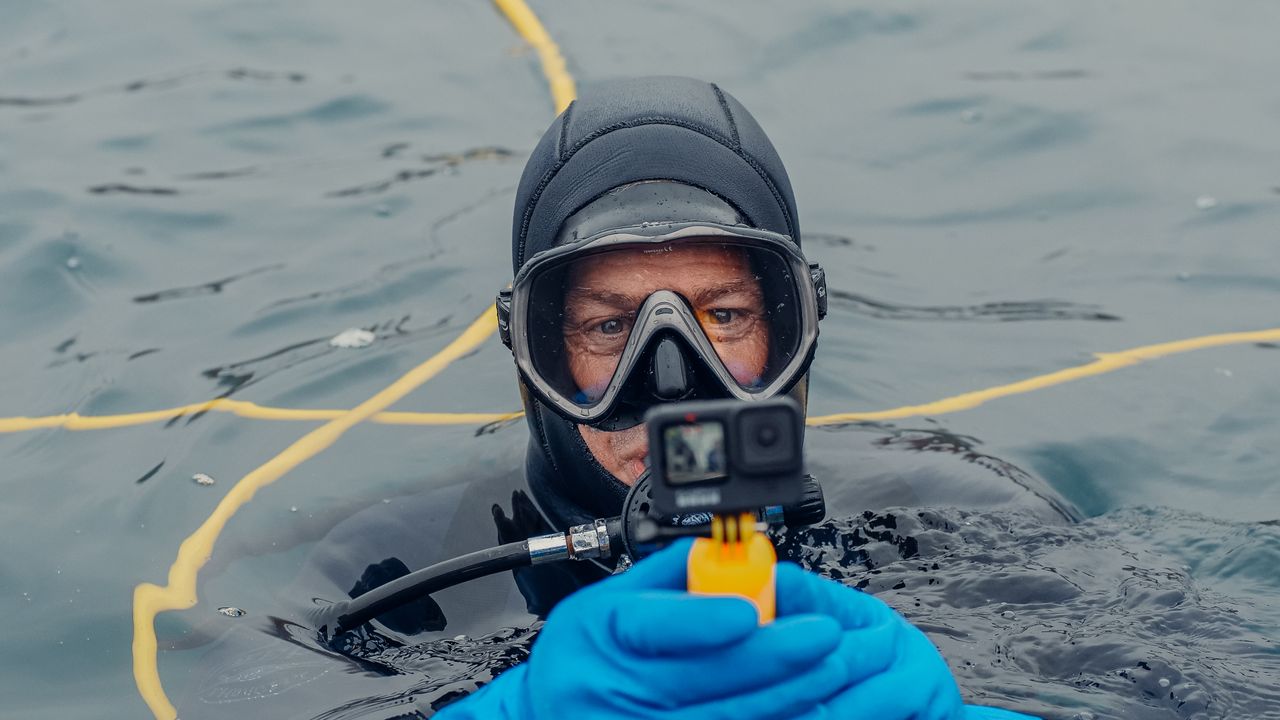 Diver at the surface holding a small camera
