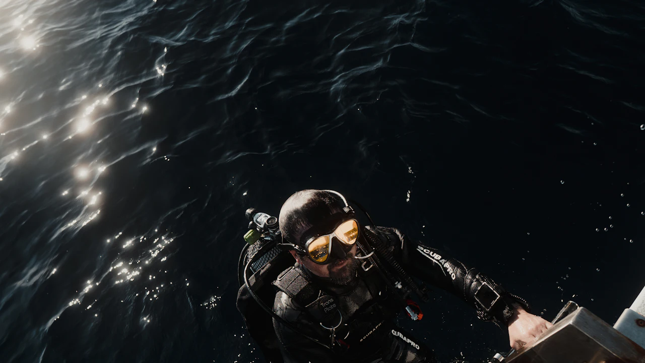 Scuba diver in a mask near the sunlit surface
