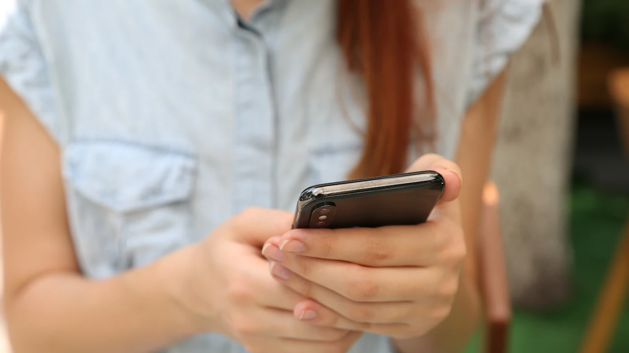 Person using a smartphone outdoors