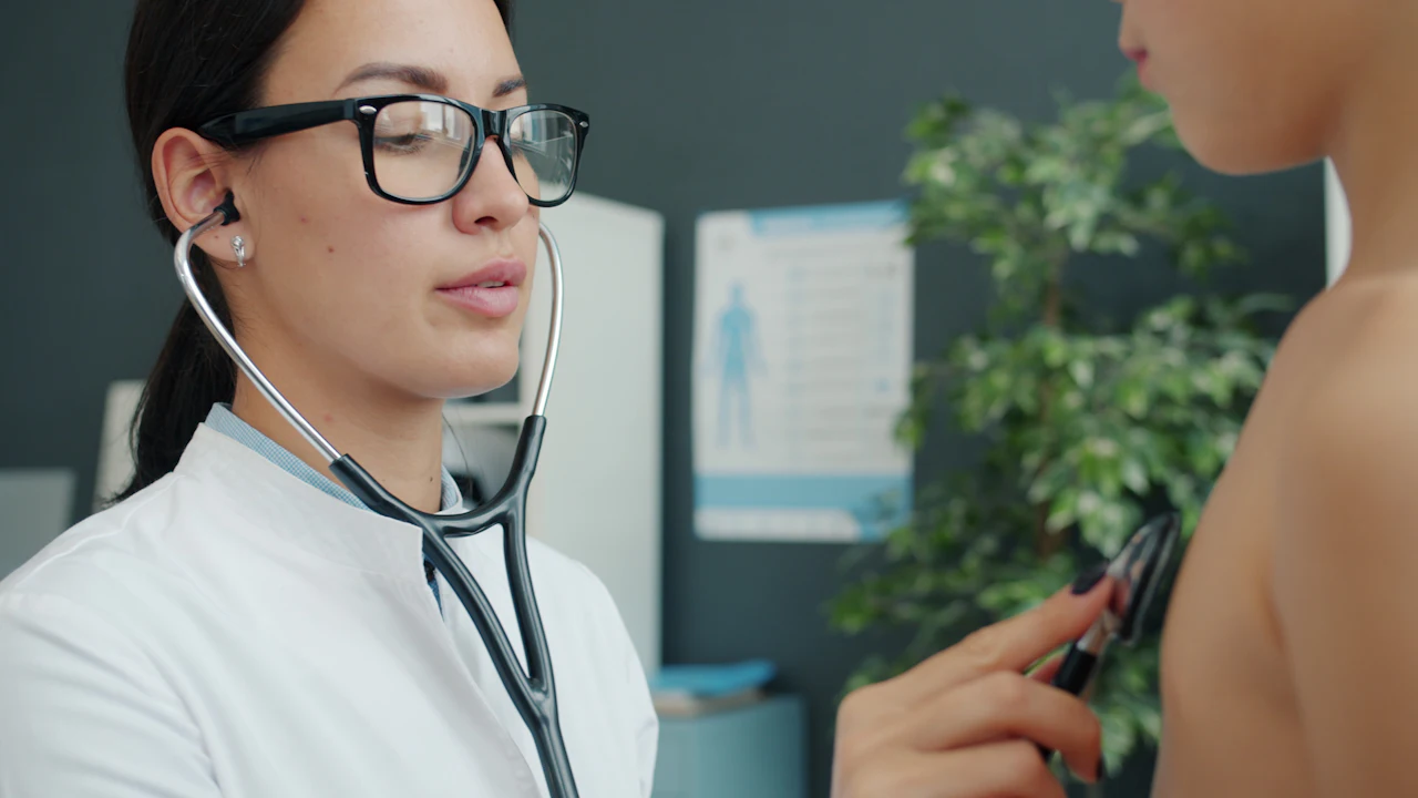Doctor with a stethoscope examining a patient in a clinic