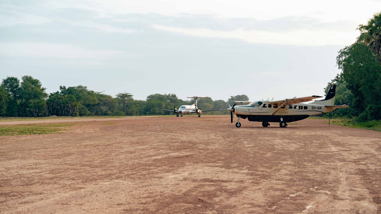 Small propeller plane parked on a grass airstrip