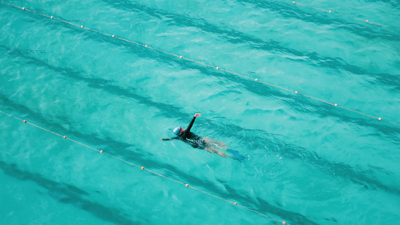 Swimmer in a pool lane seen from above