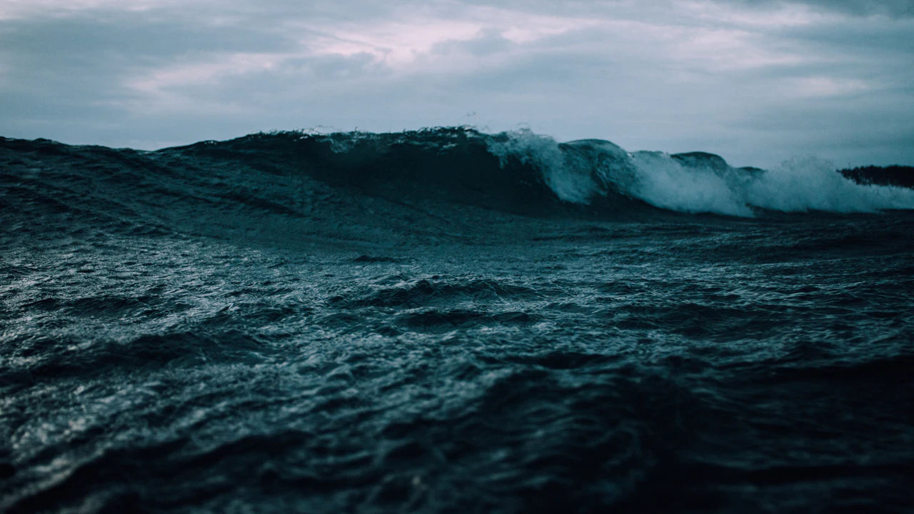 Choppy gray sea with whitecaps building under a cloudy sky