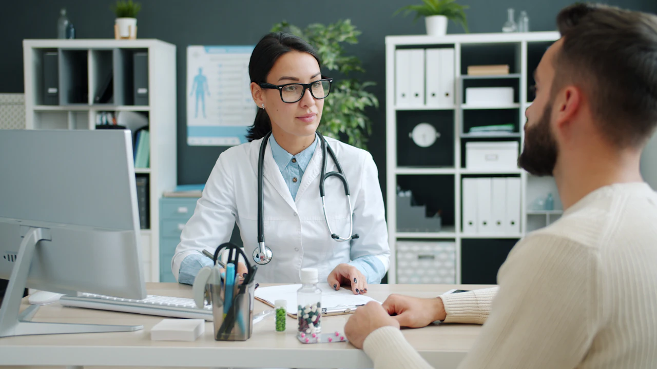 Doctor talking with a patient across a desk