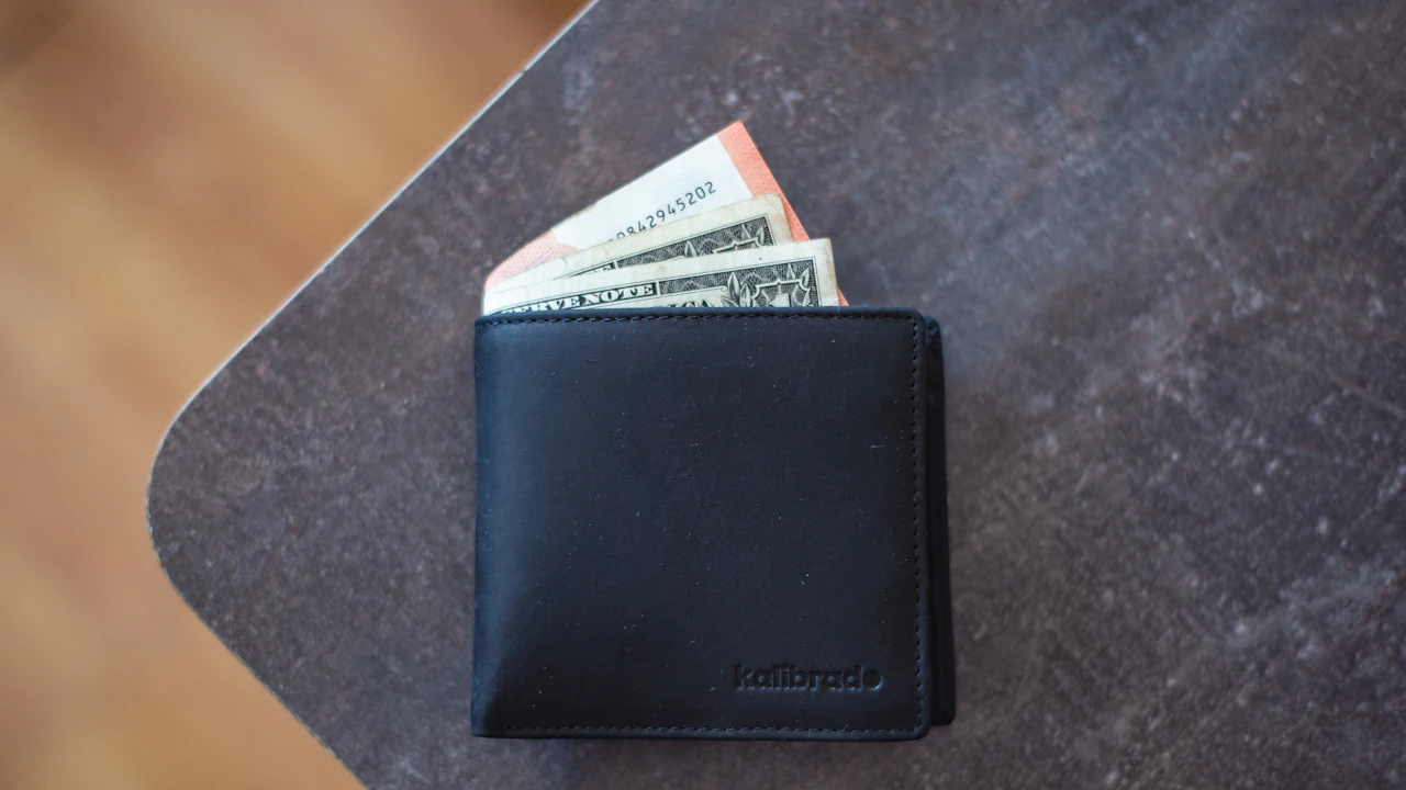 Wallet with cash on a table