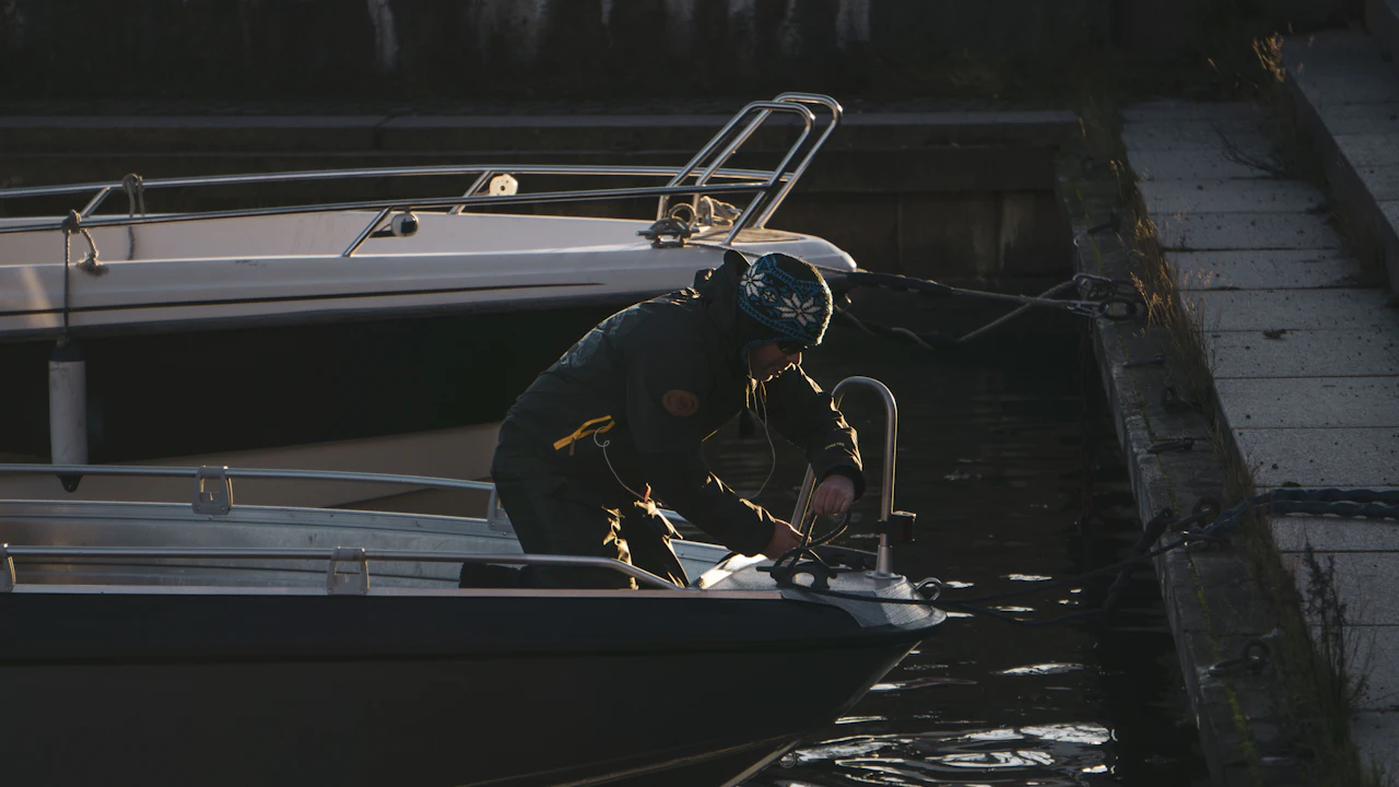 Man working on a boat deck at dusk