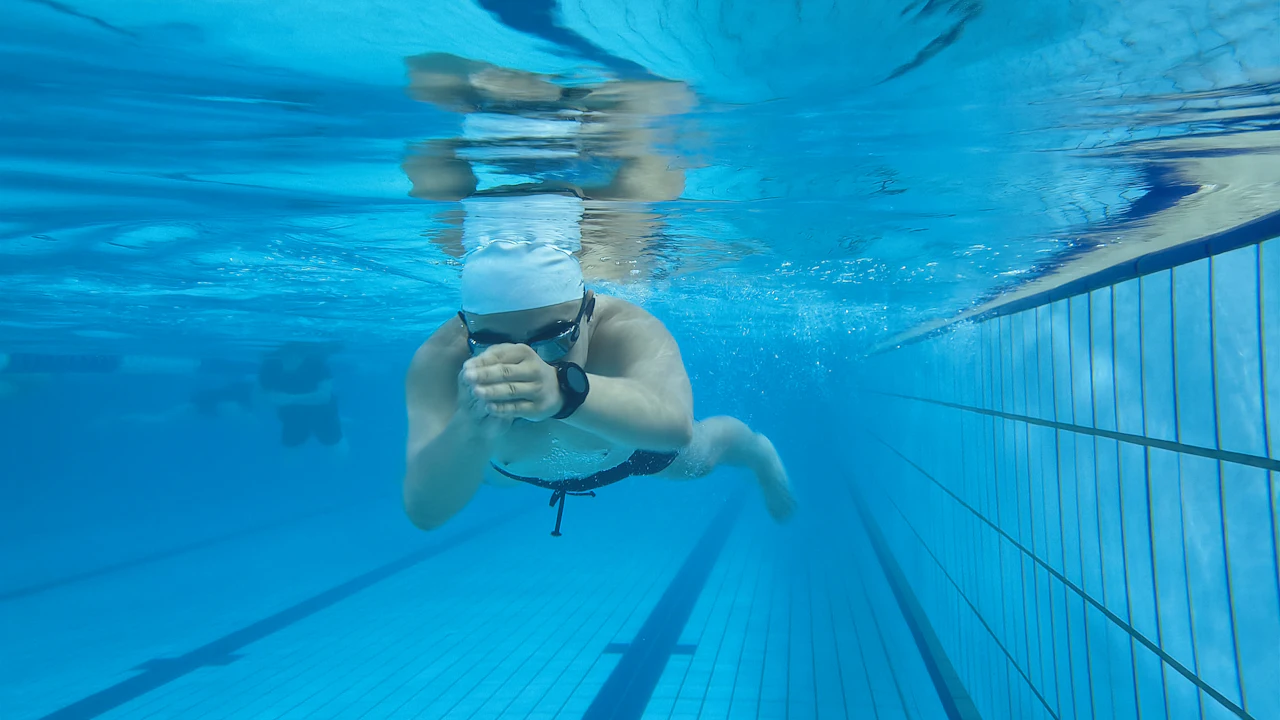 Swimmer underwater in a lane of a swimming pool