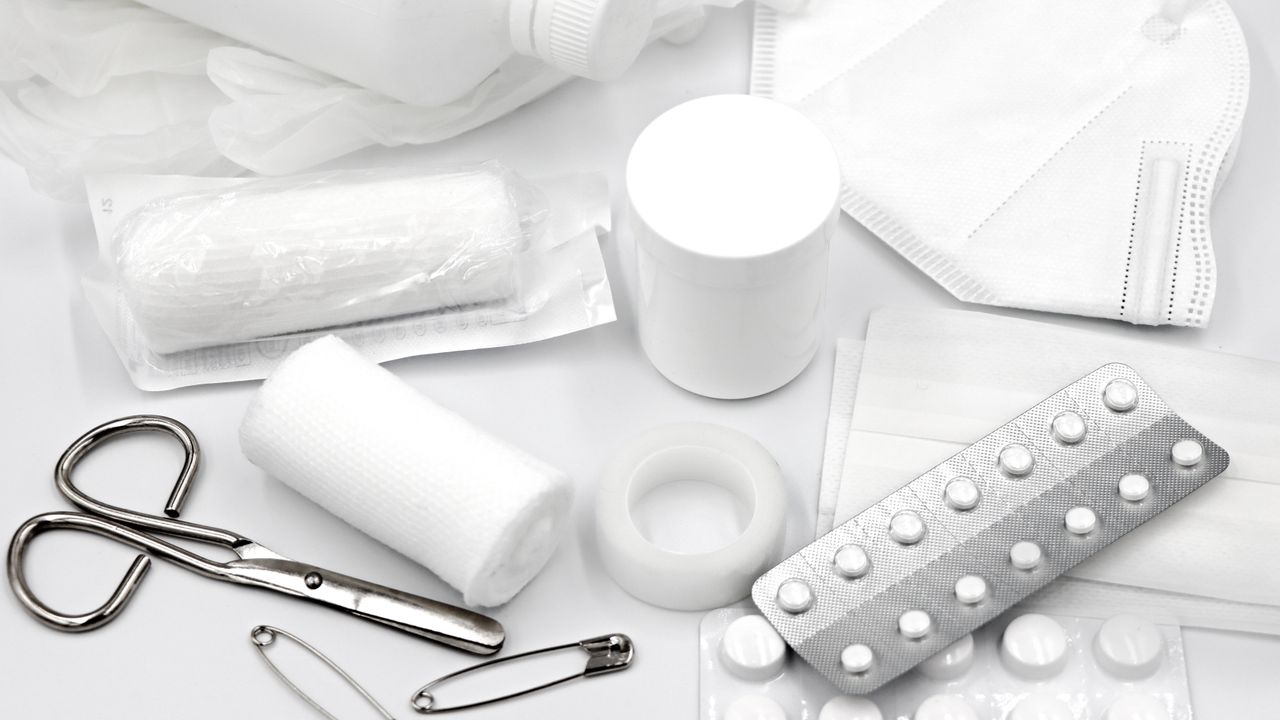 First aid supplies: bandages, tablets and scissors