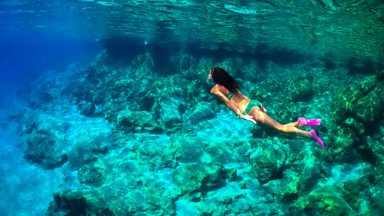Snorkeler swimming over a shallow reef