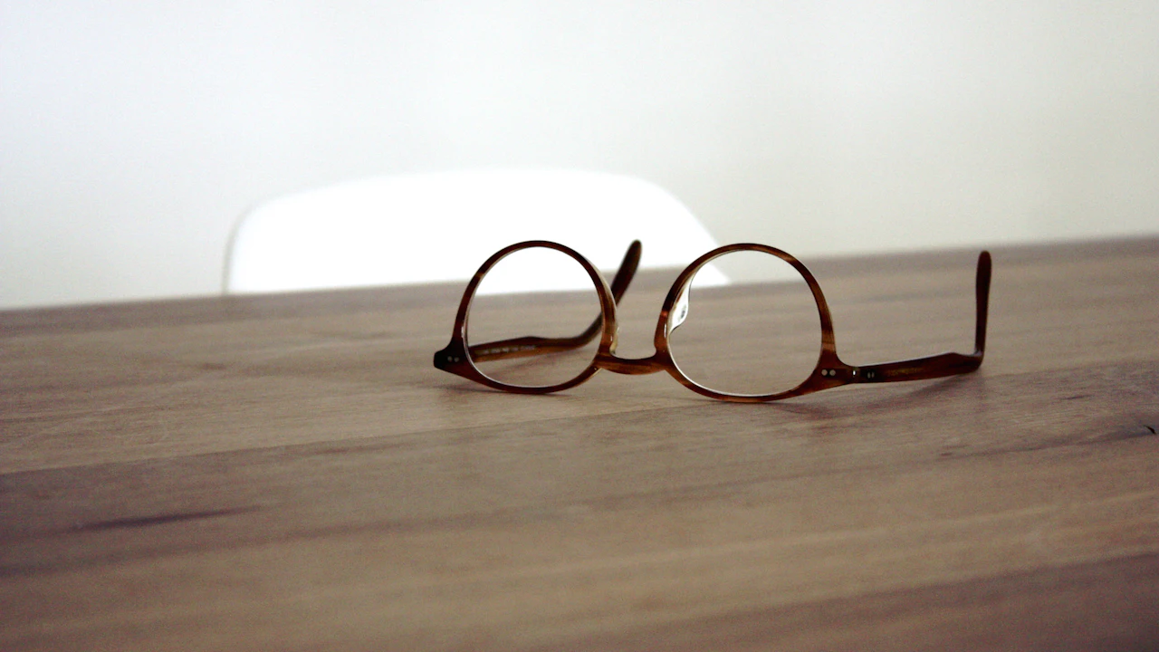Pair of eyeglasses on a wooden table
