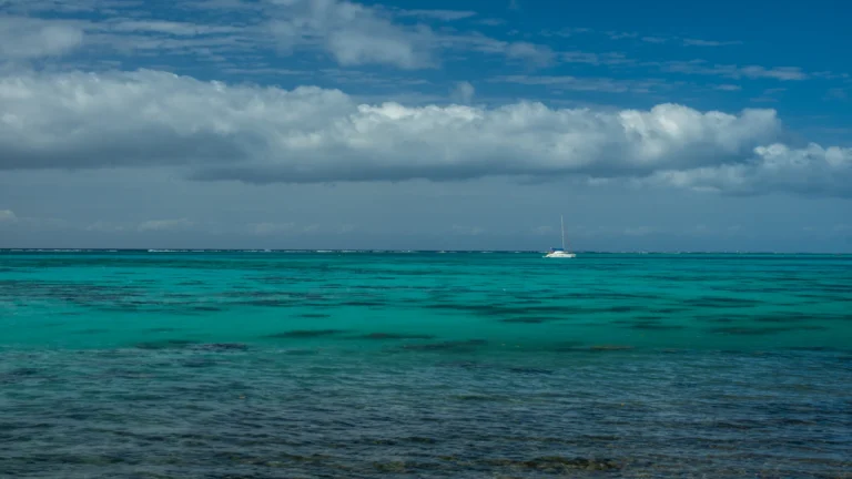 Turquoise water and a distant reef line under a cloudy sky