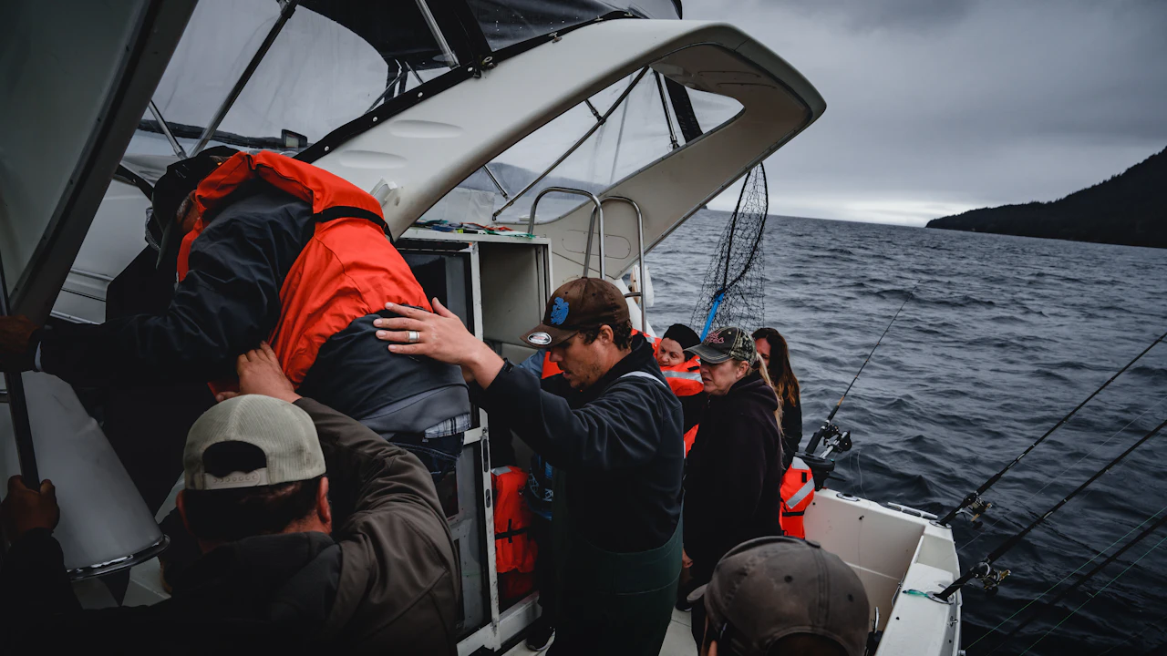 Group in jackets gathered on the deck of a boat