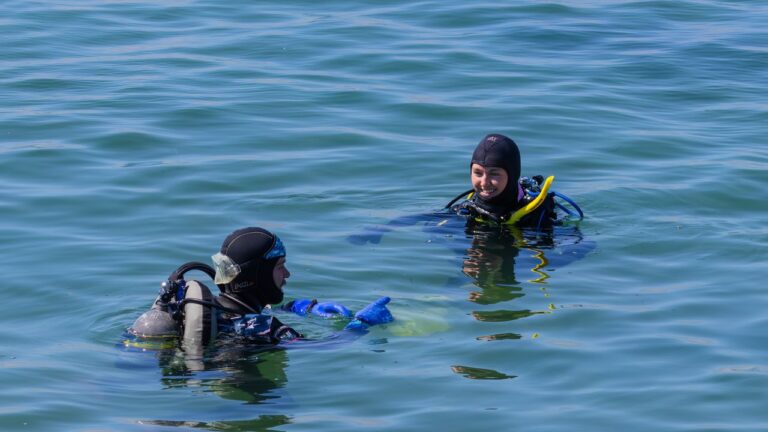Two scuba divers at the surface during a training exercise