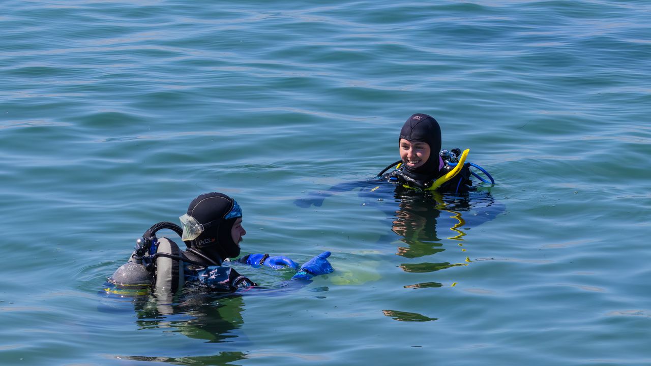 Two scuba divers at the surface during a training exercise