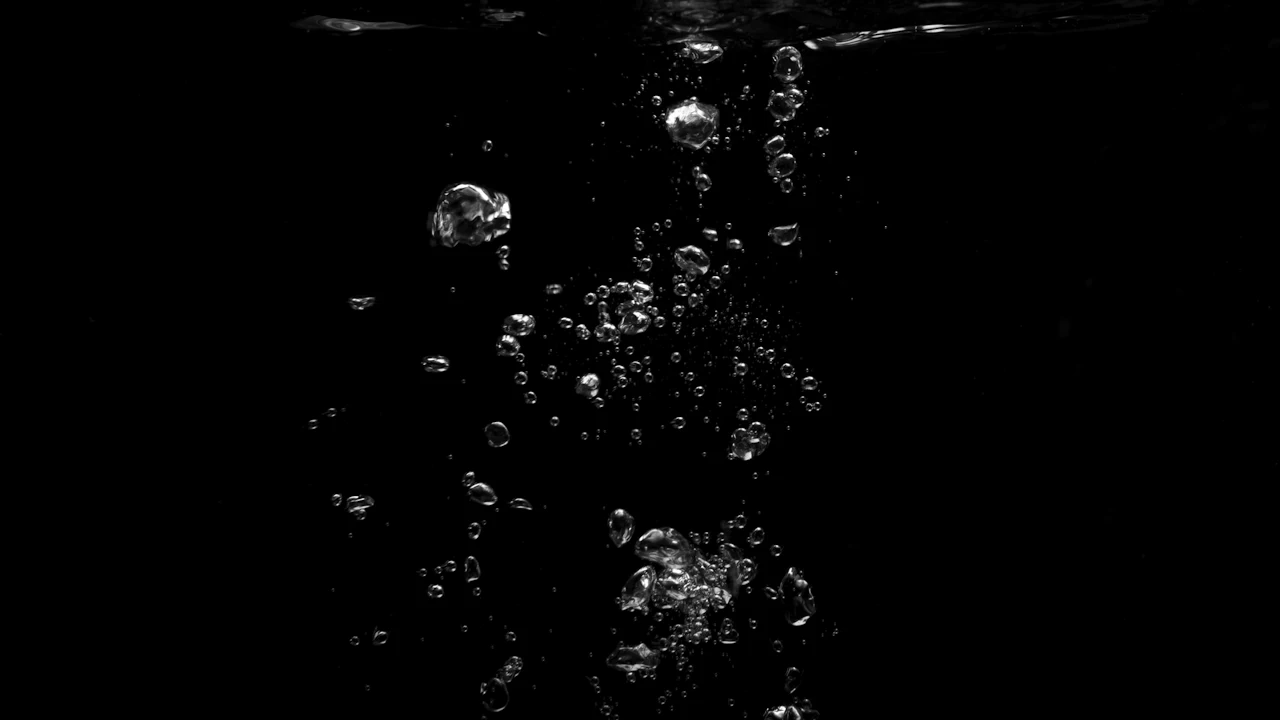 Bubbles rising in dark water