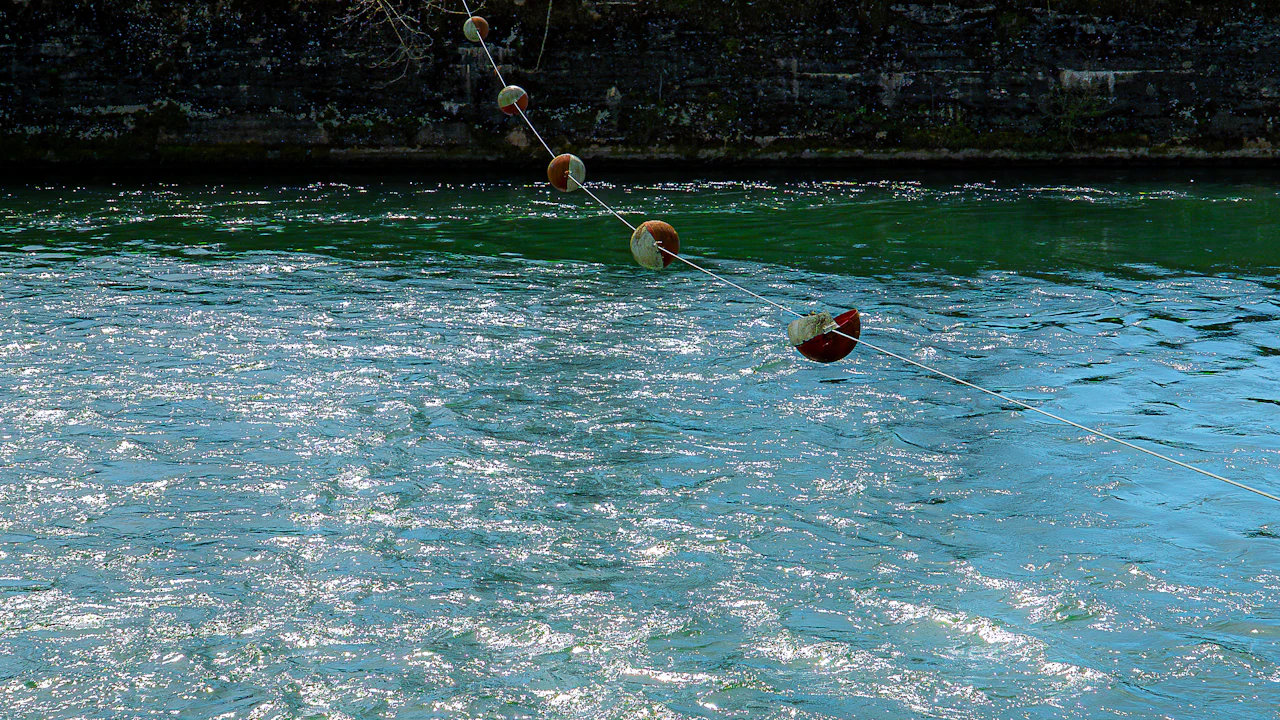 Rope line with floats stretched across clear water