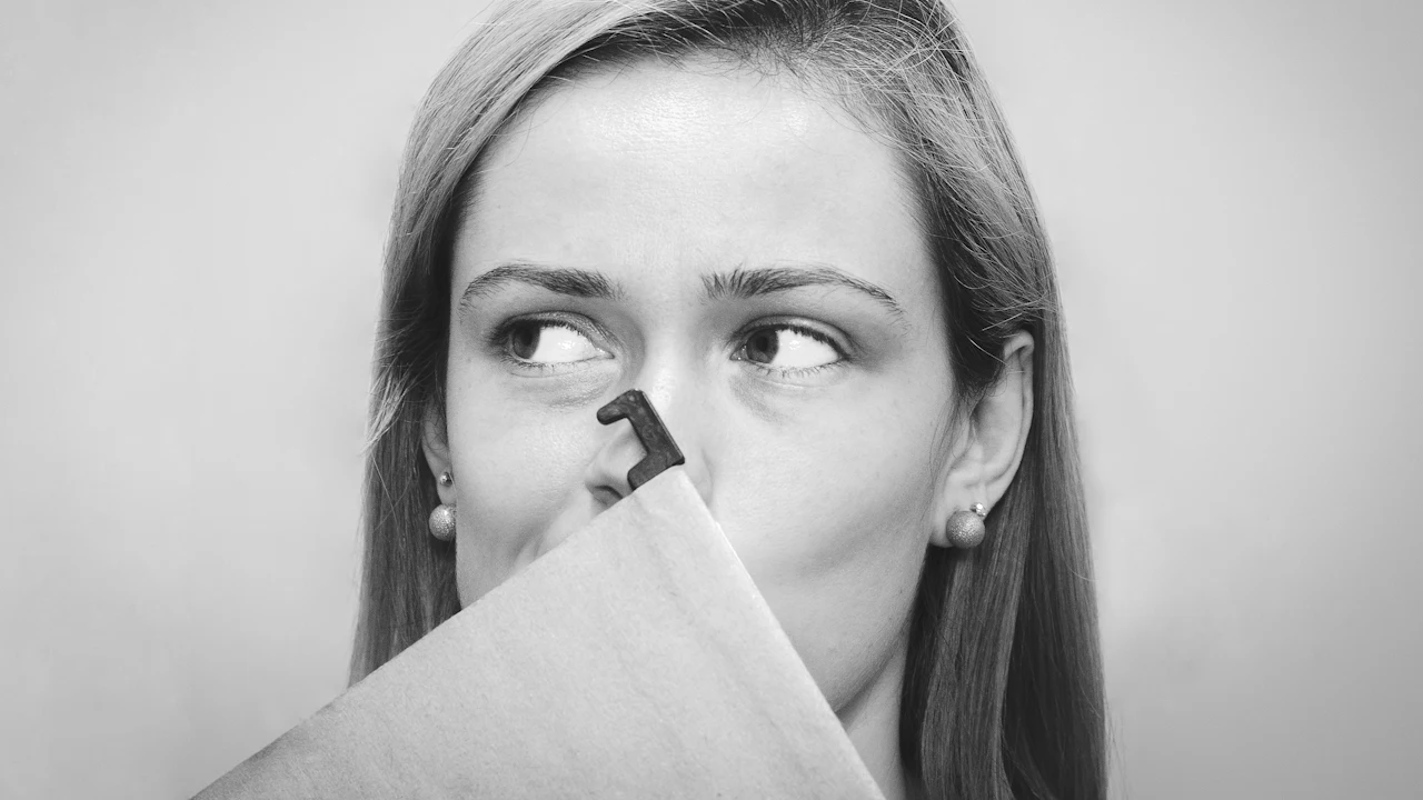 Woman holding a tissue to her nose