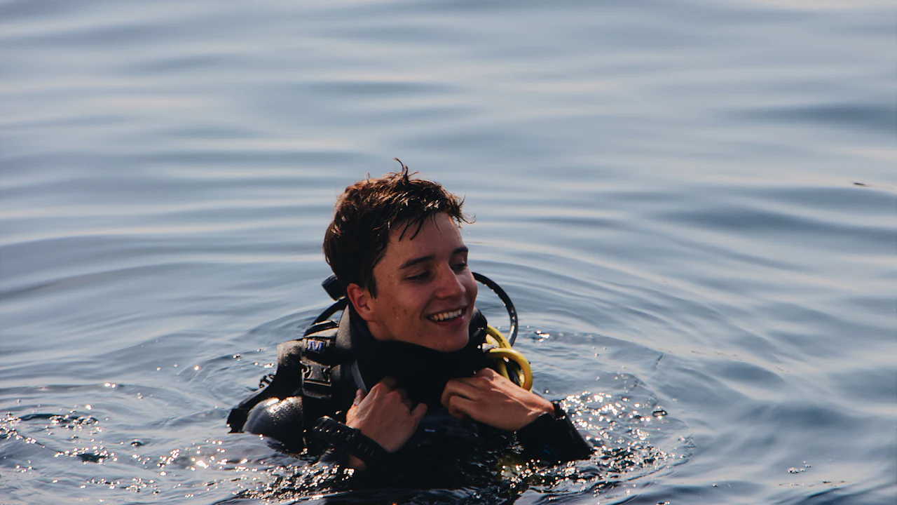 Smiling scuba diver floating at the surface after a dive