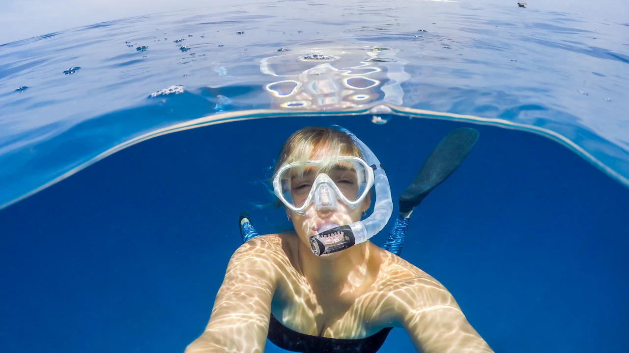 Snorkeler in a clear mask just below the surface