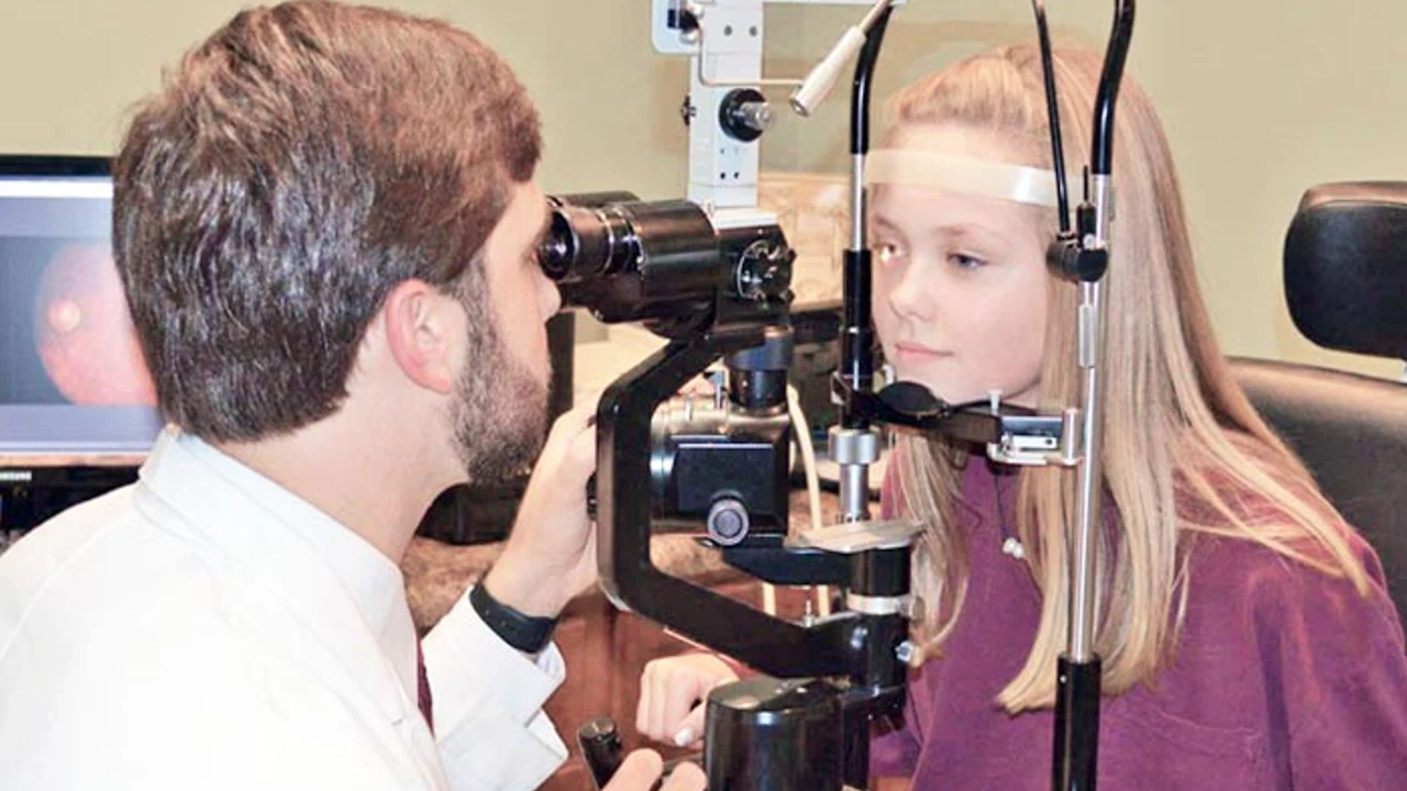 Eye doctor examining a patient's eyes during a routine eye exam