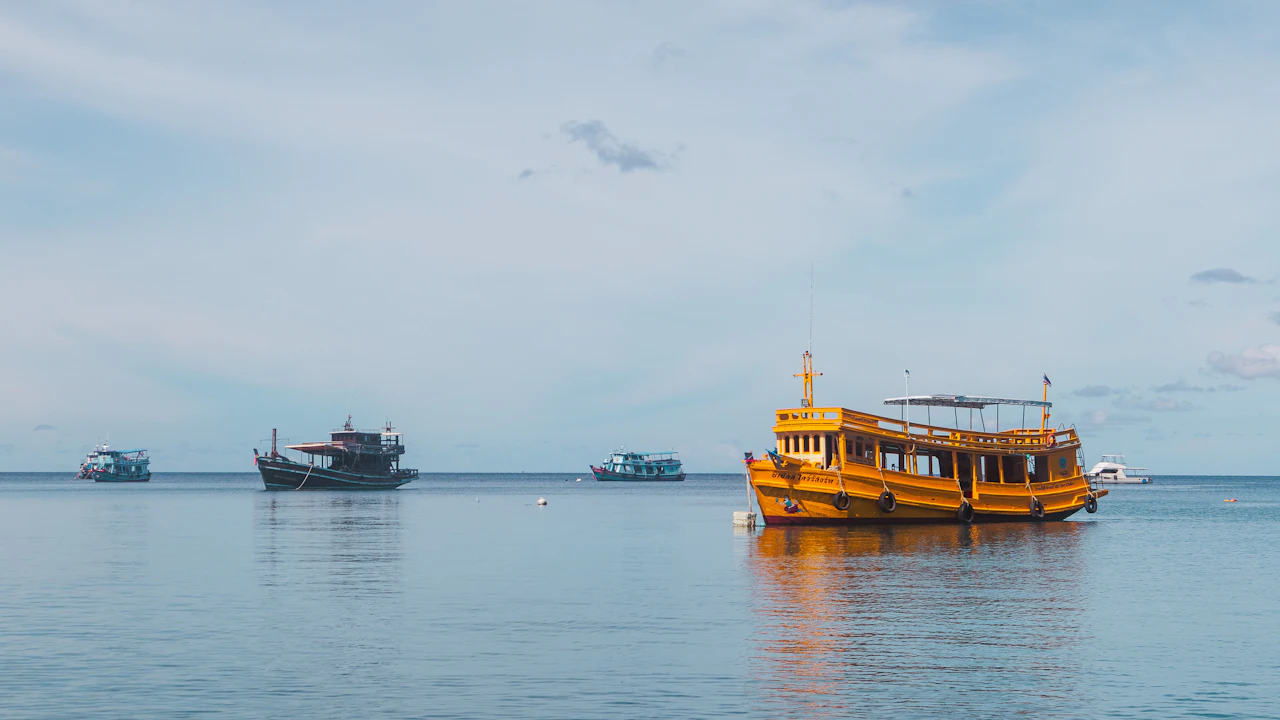 Wooden dive boat and other boats on a calm sea