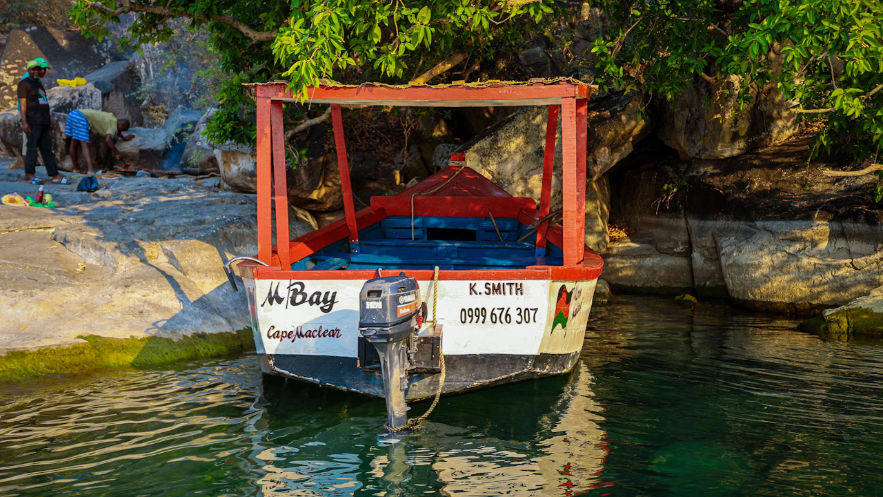 Small boat moored by a rocky shore