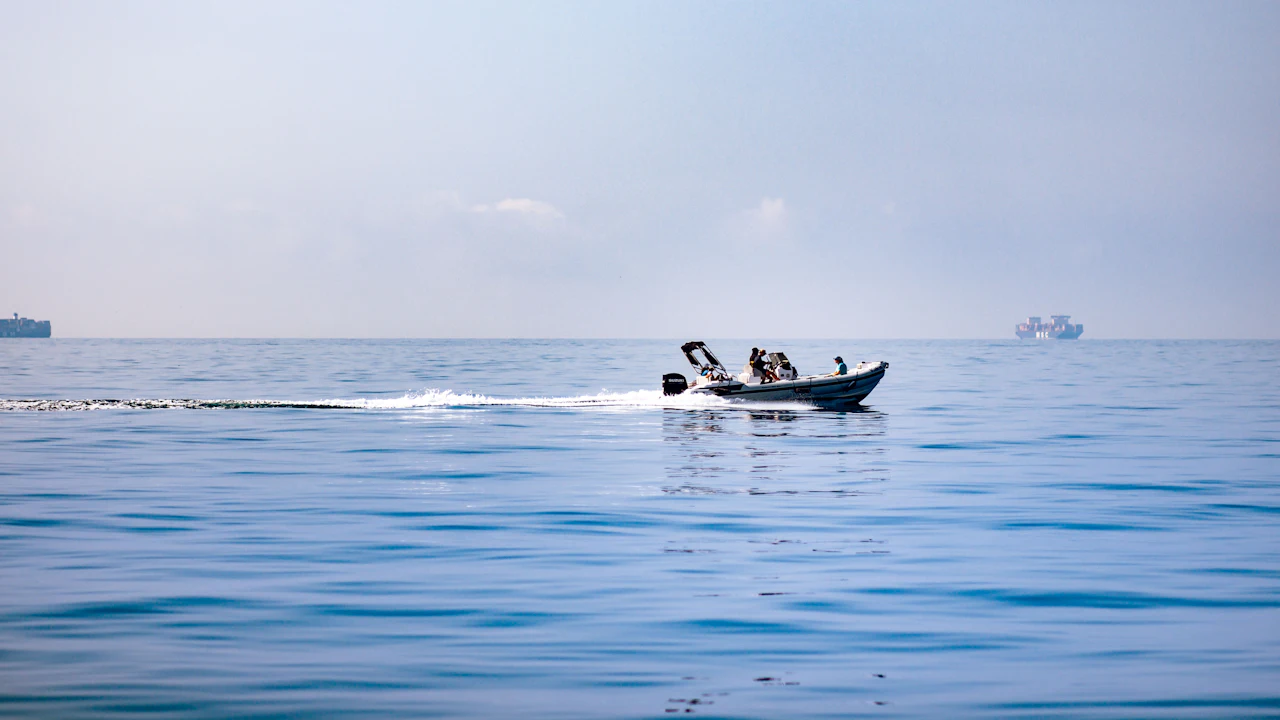 Small boat crossing a calm open sea