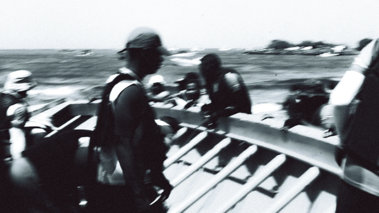People gearing up on a small boat in black and white