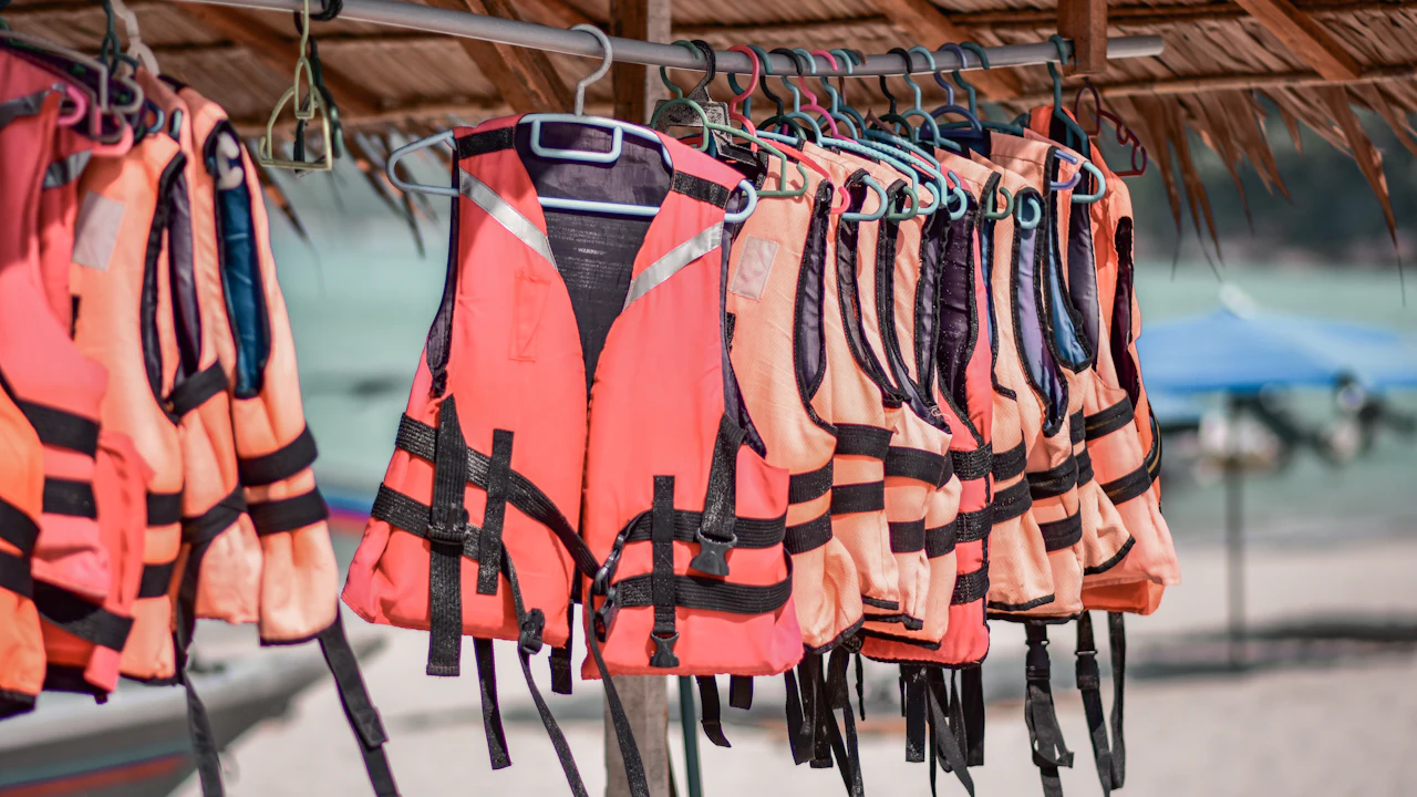 Bright orange life vests hanging in a row