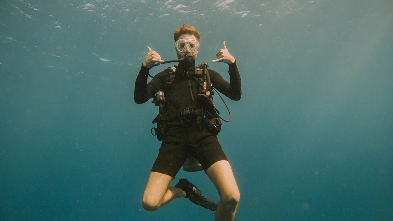Scuba diver underwater making hand signs