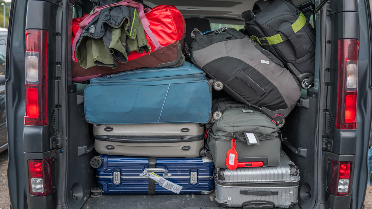 Luggage packed into the back of a van