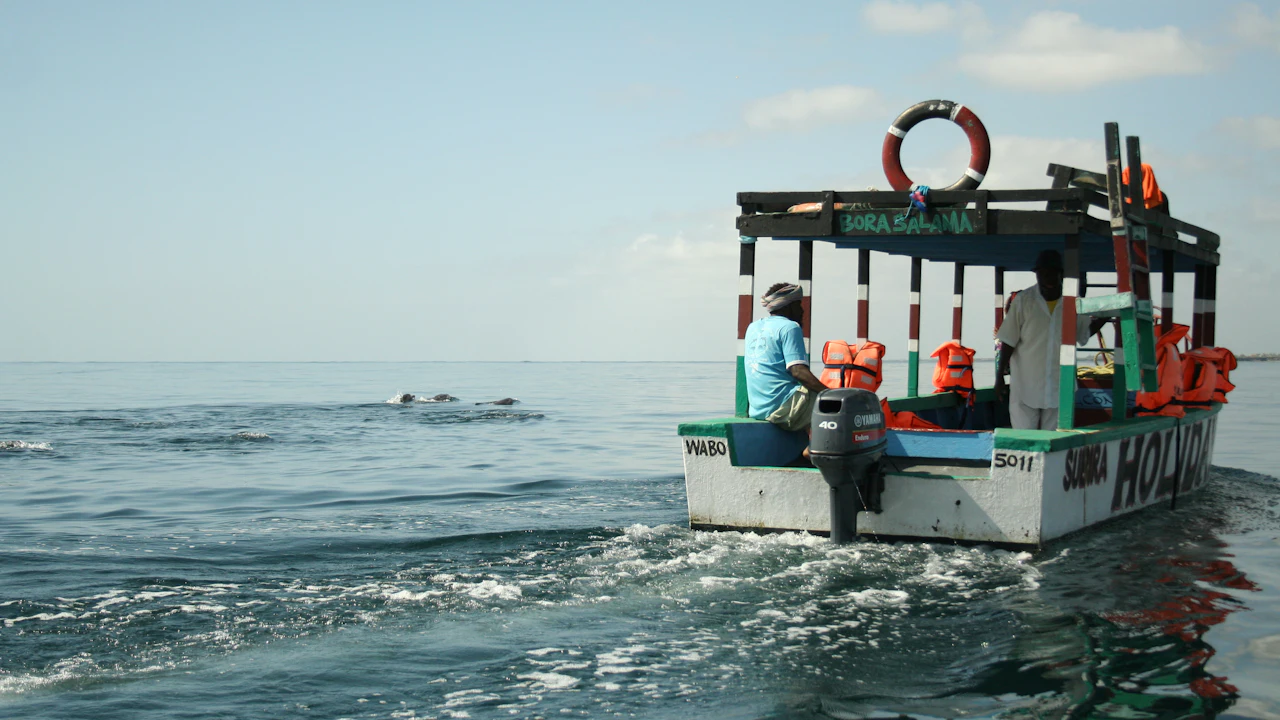 Dive boat loaded with scuba tanks crossing open sea on a sunny day