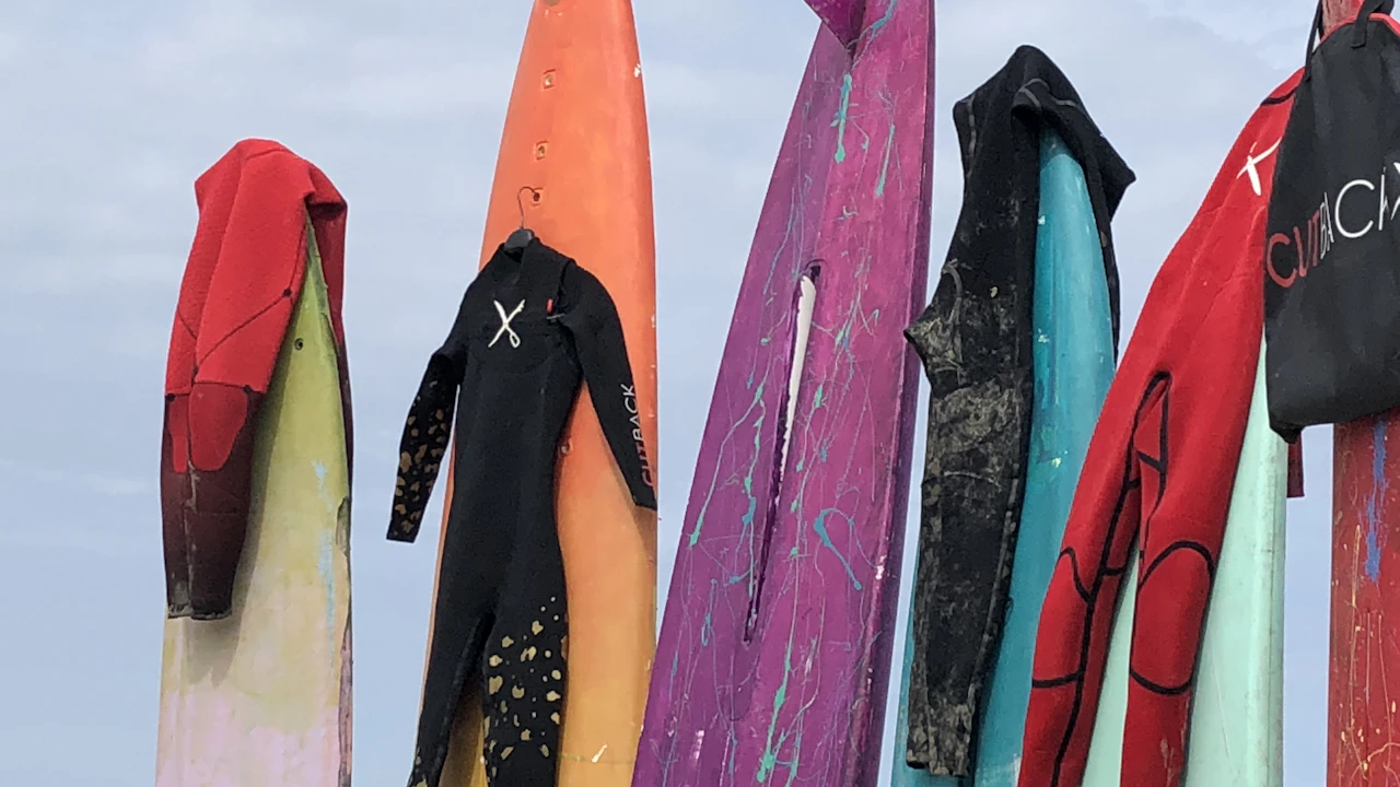 Wetsuits and surfboards hanging up to dry